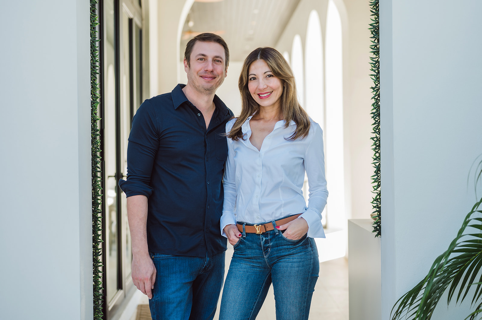 Smiling couple standing in modern officeRetry