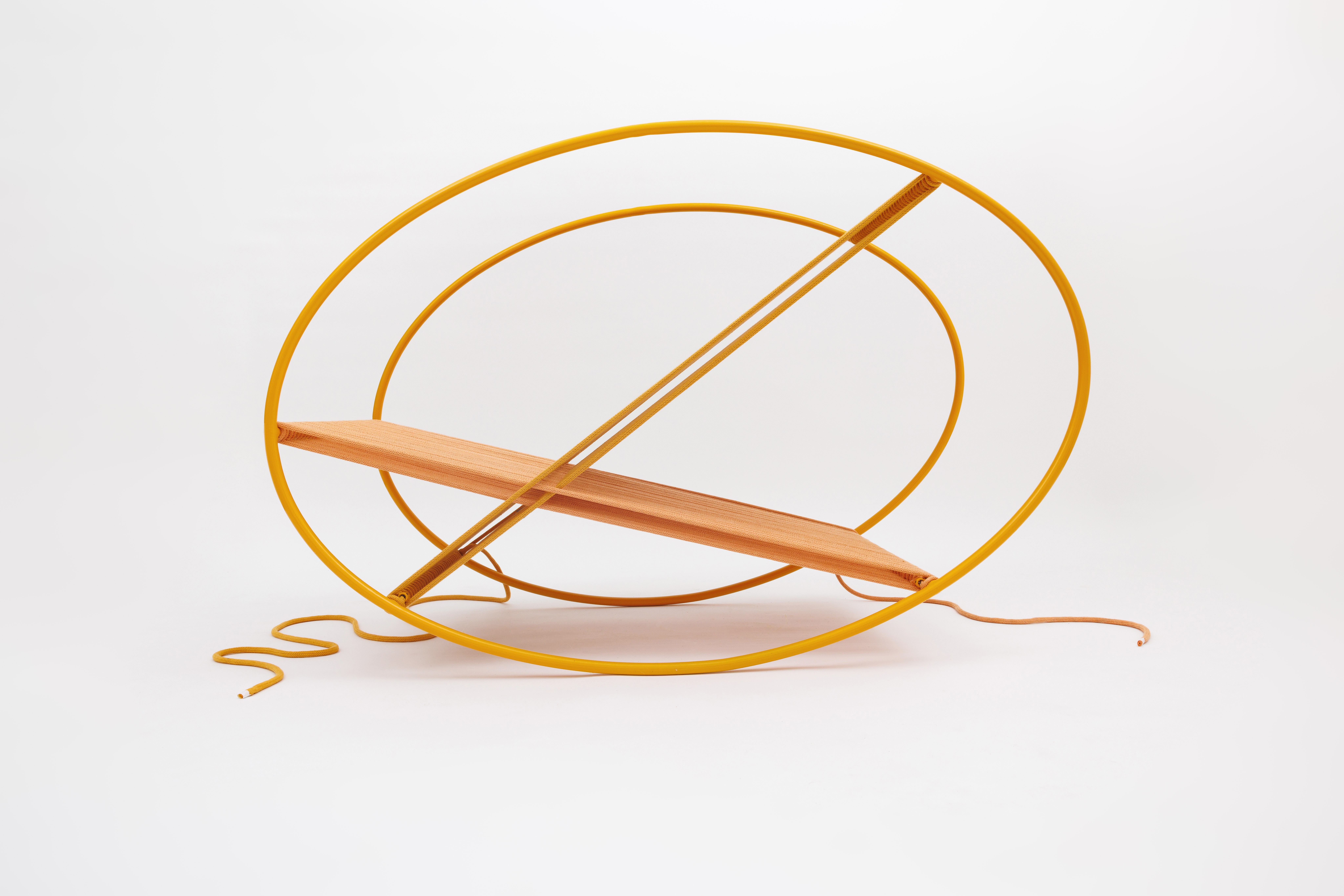 Orange and yellow geometric sculpture with circular and linear elements on a white background.