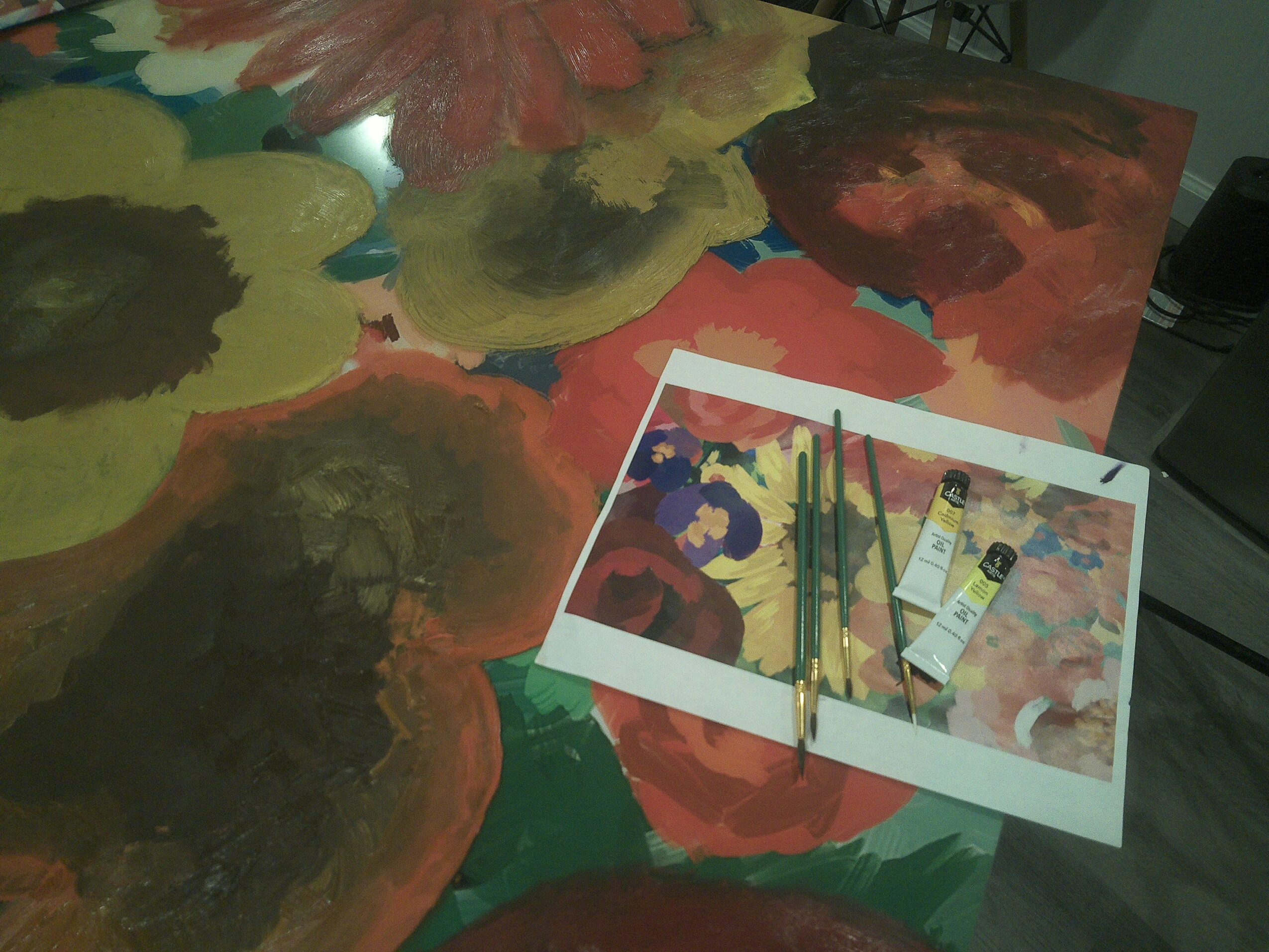 Paint palette with brushes and tubes of paint on a colorful abstract background.