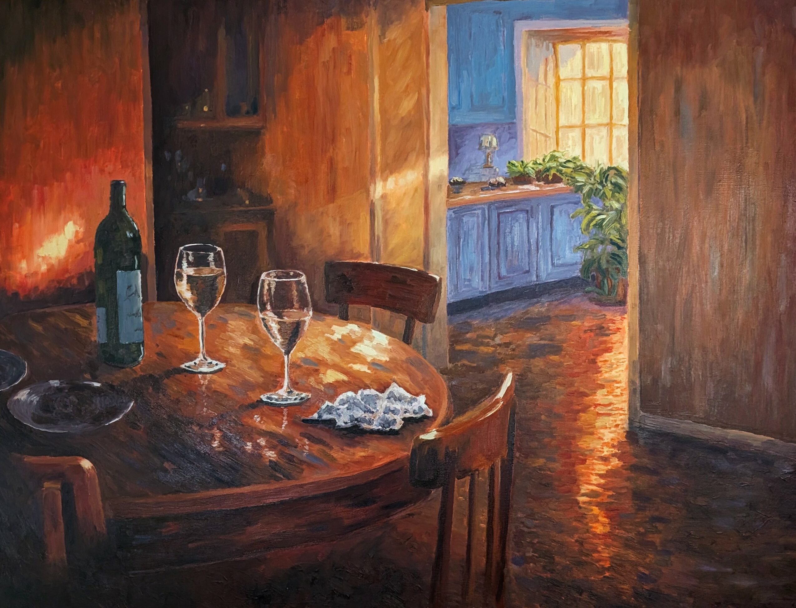Dining room with a round table, wine bottle, glasses, and a window with sunlight, wooden floors and walls.