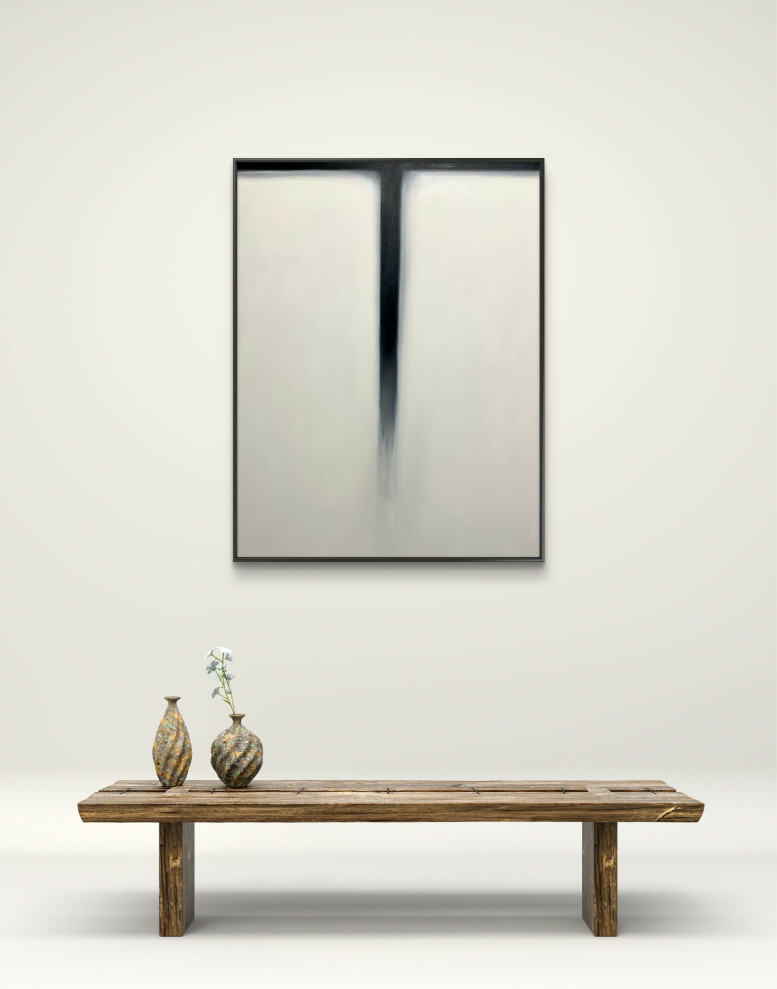 Framed abstract artwork with black and white vertical streaks hangs above a wooden bench with two vases and a plant.