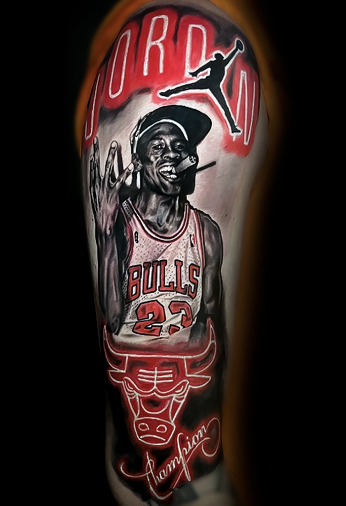 Tattoo of Michael Jordan in a Chicago Bulls jersey, with a basketball and Jumpman logo, and signature.