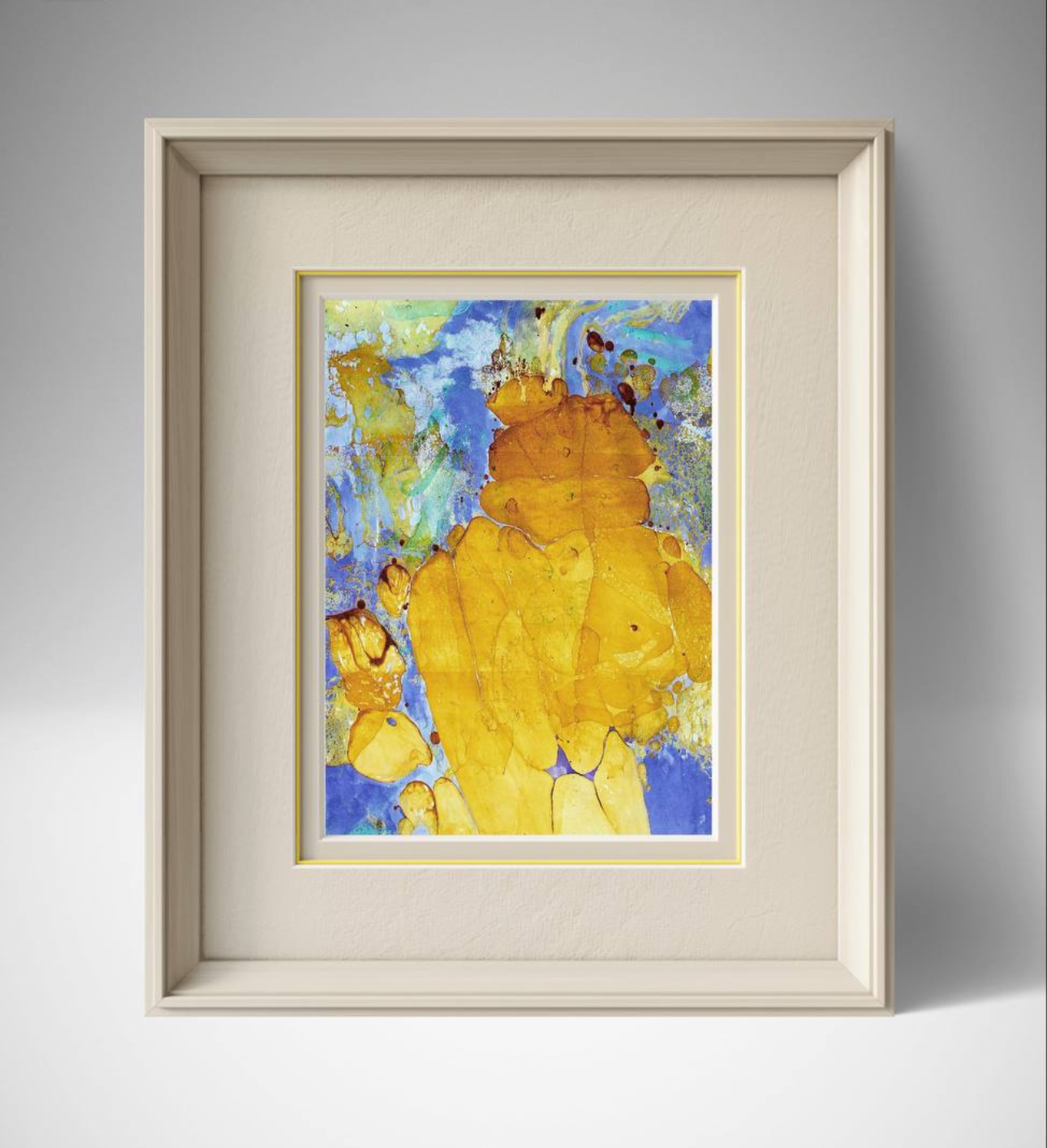 Framed abstract watercolor painting with blue, yellow, and orange colors on a gray wall.