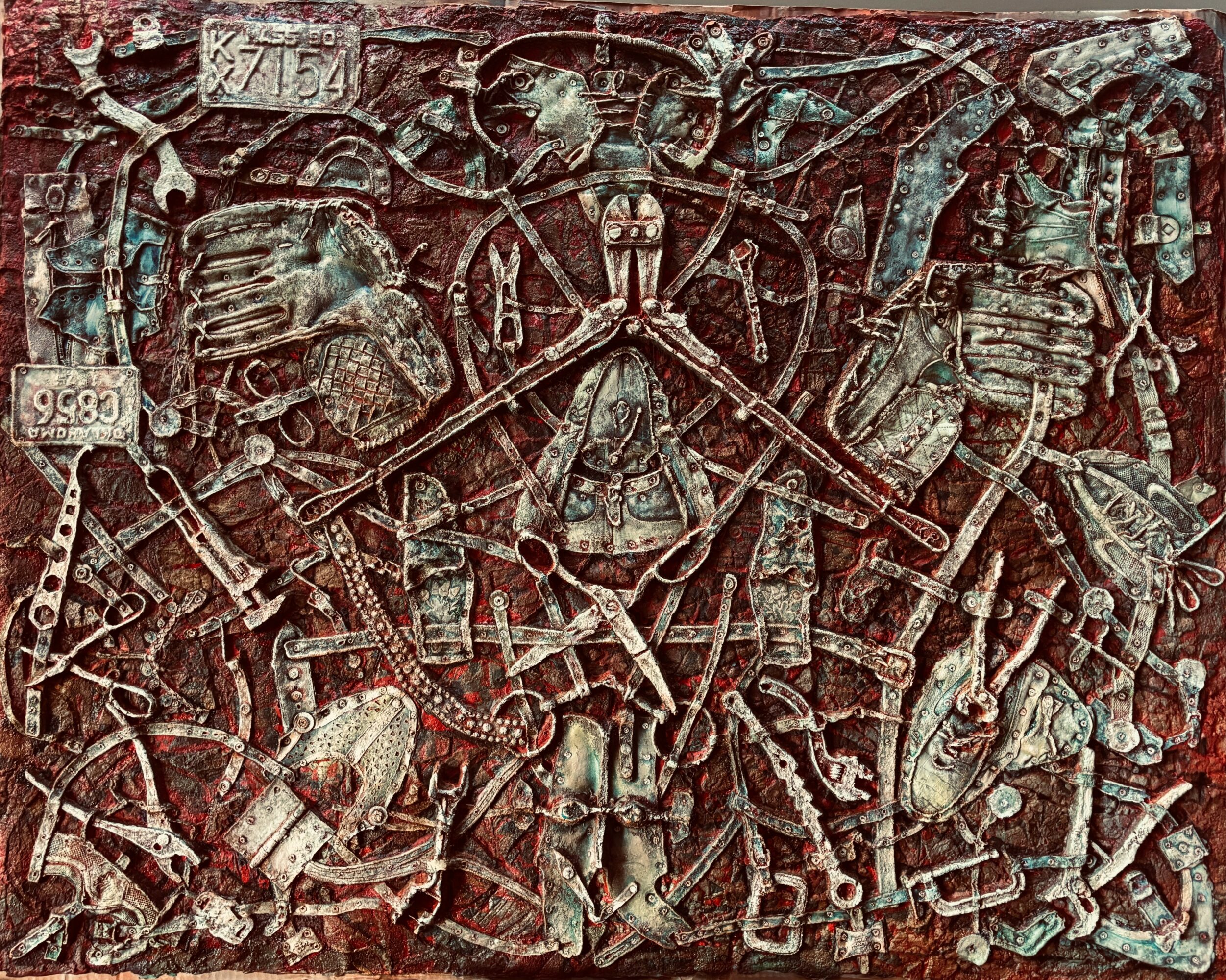Intricate ancient carved stone relief depicting various figures, symbols, and objects in a complex scene.