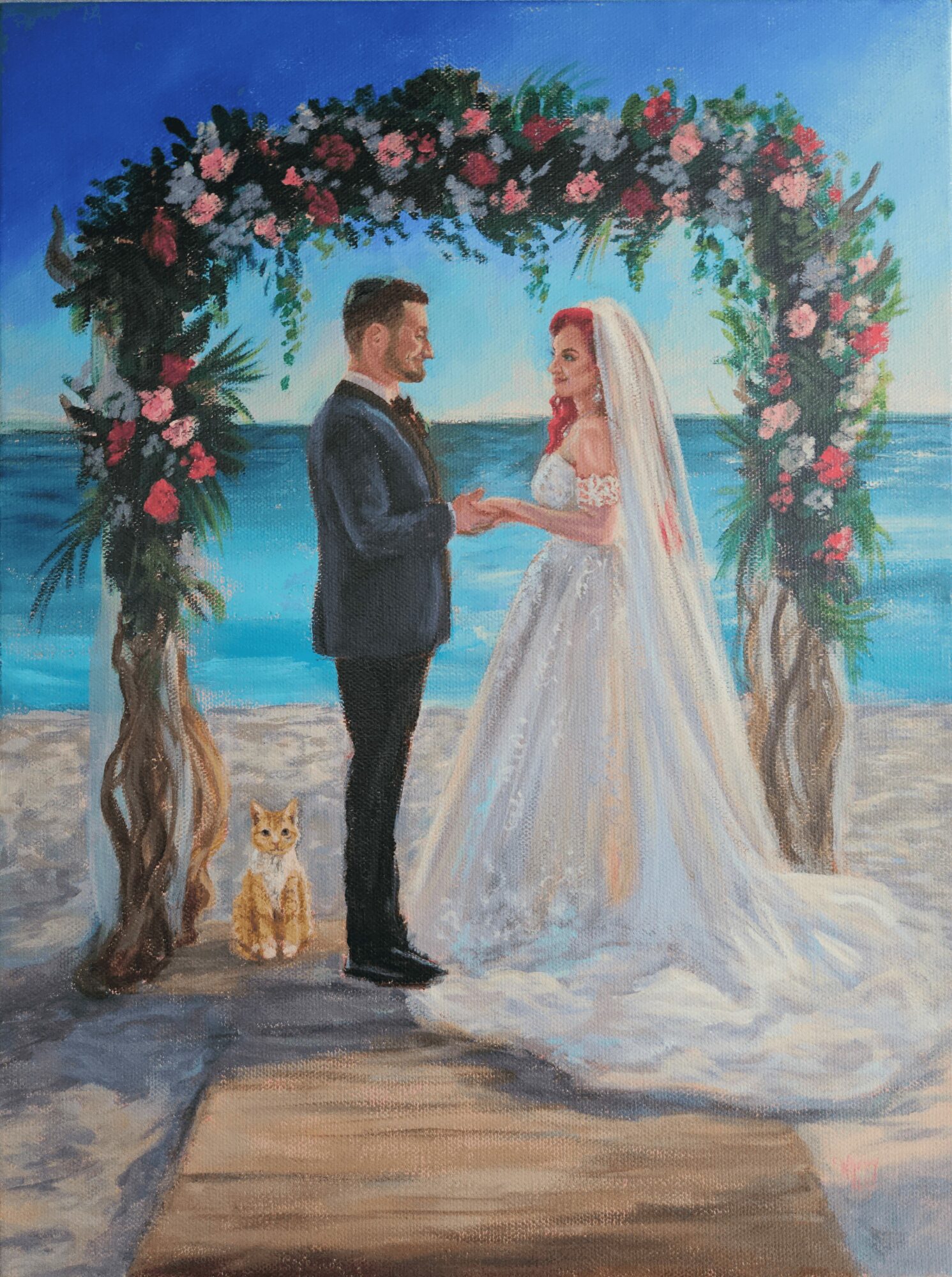 A bride and groom stand under a floral arch on a beach, holding hands, with a cat nearby, ocean in background.