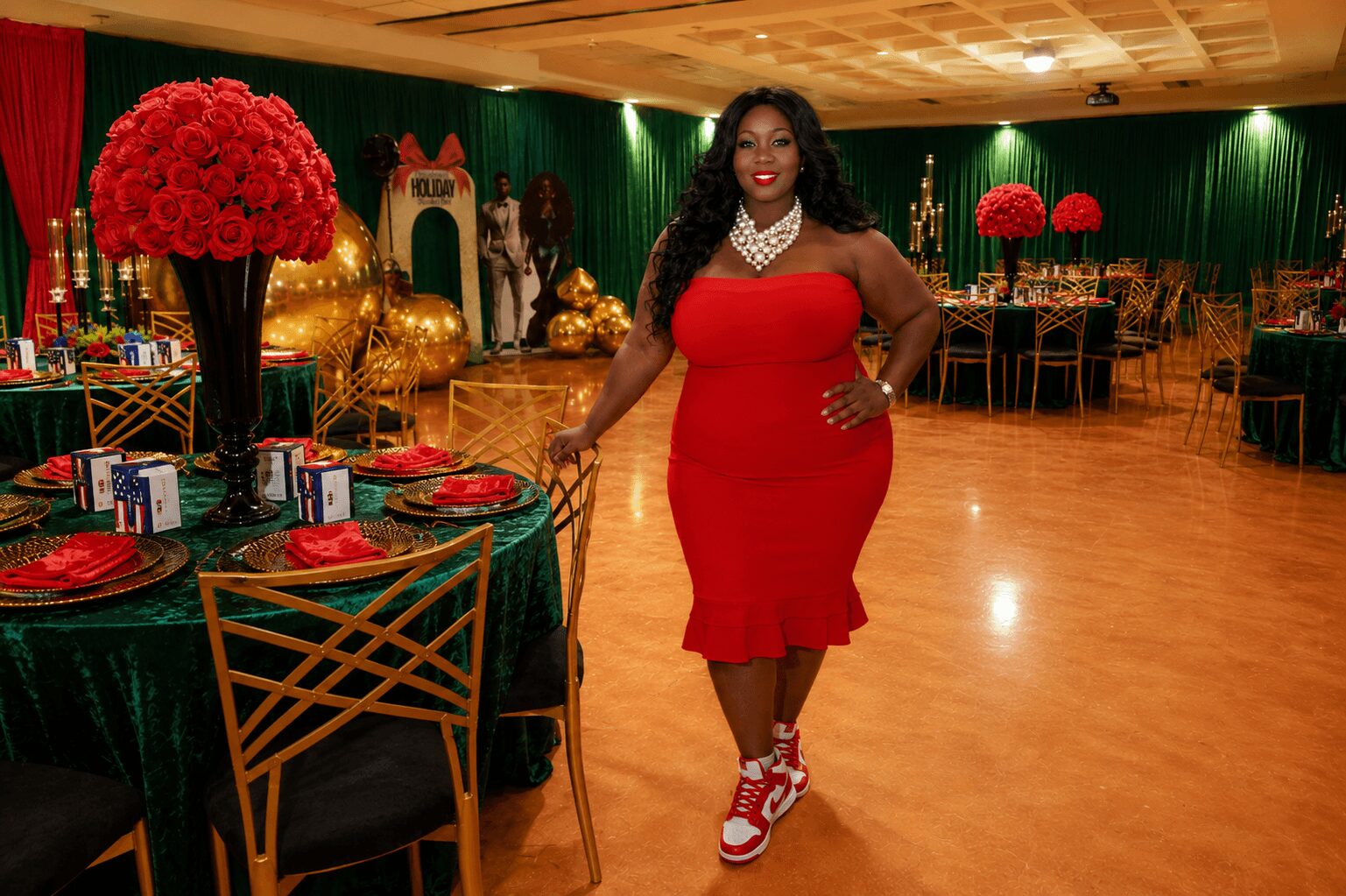 Woman in red dress and sneakers standing in decorated event hall with tables and floral arrangements.