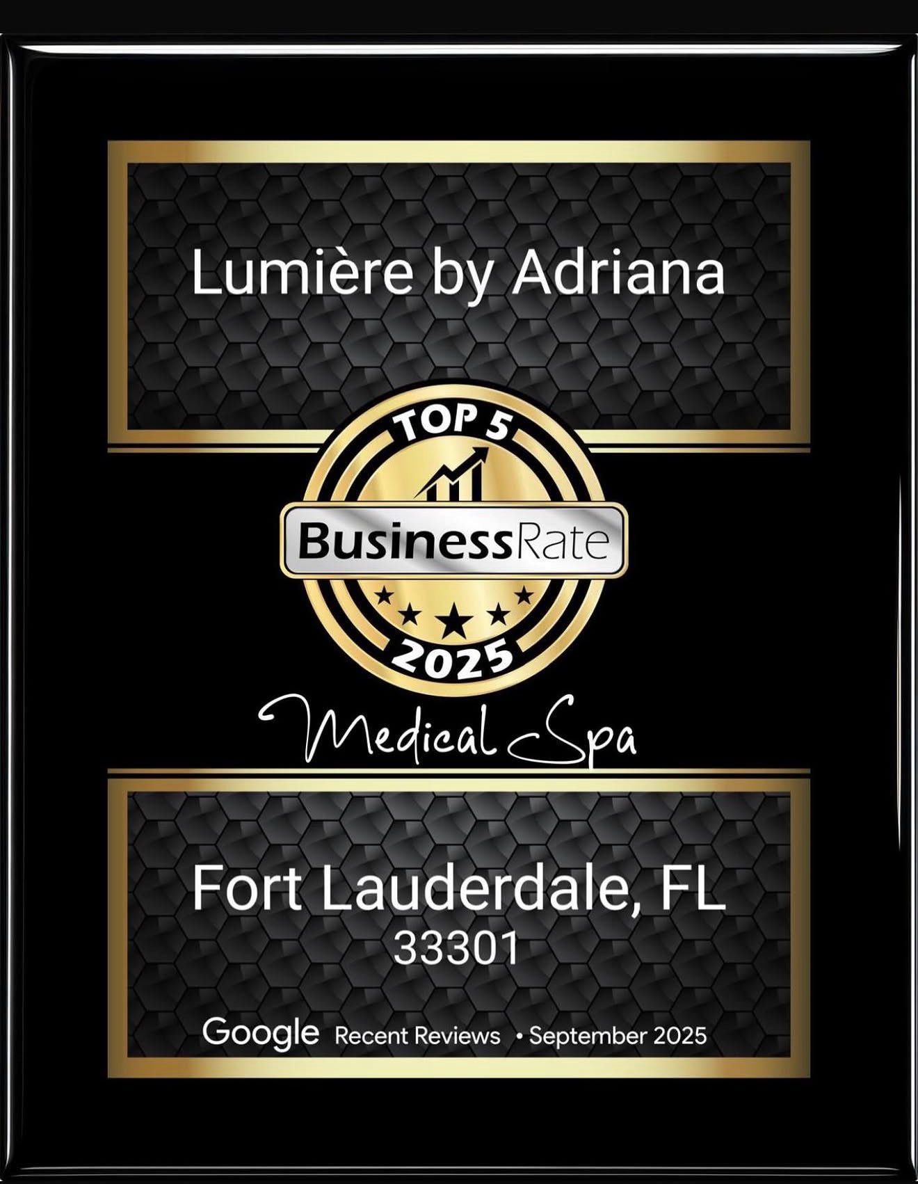 Framed award plaque with black background, gold accents, and text about a medical spa in Fort Lauderdale, Florida.
