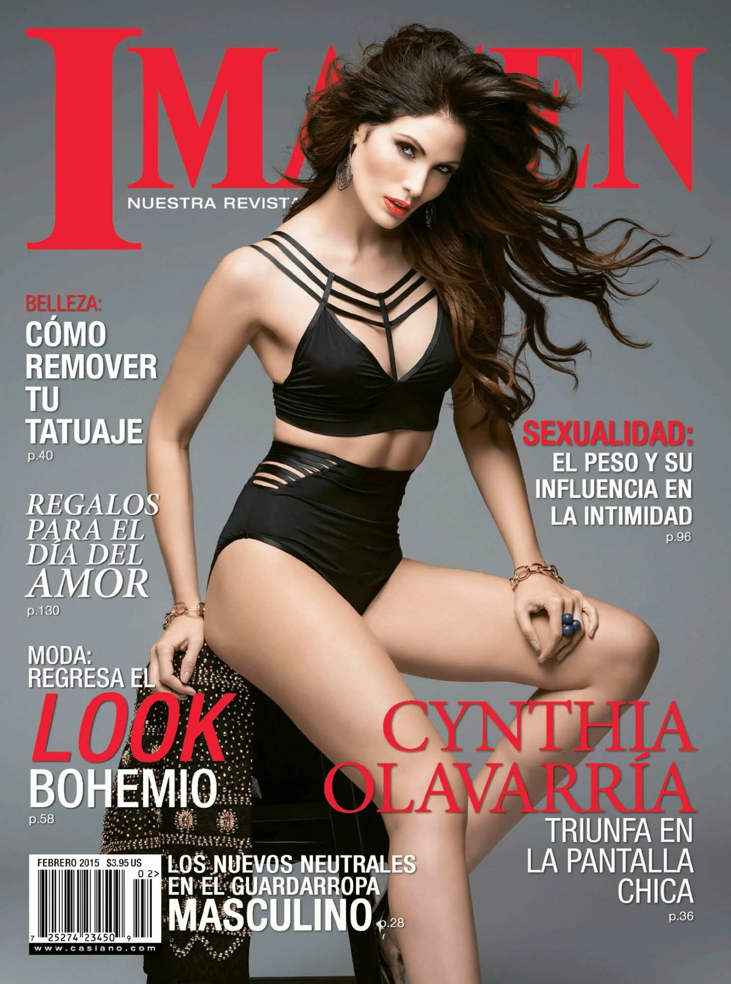 Woman with long hair in black outfit sitting, magazine cover with red and white text, gray background.
