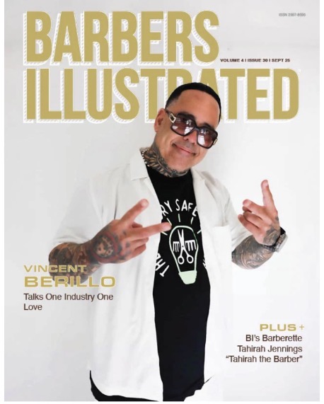 Man with tattoos and glasses smiling, wearing a white jacket and black shirt, making hand gestures, on magazine cover.