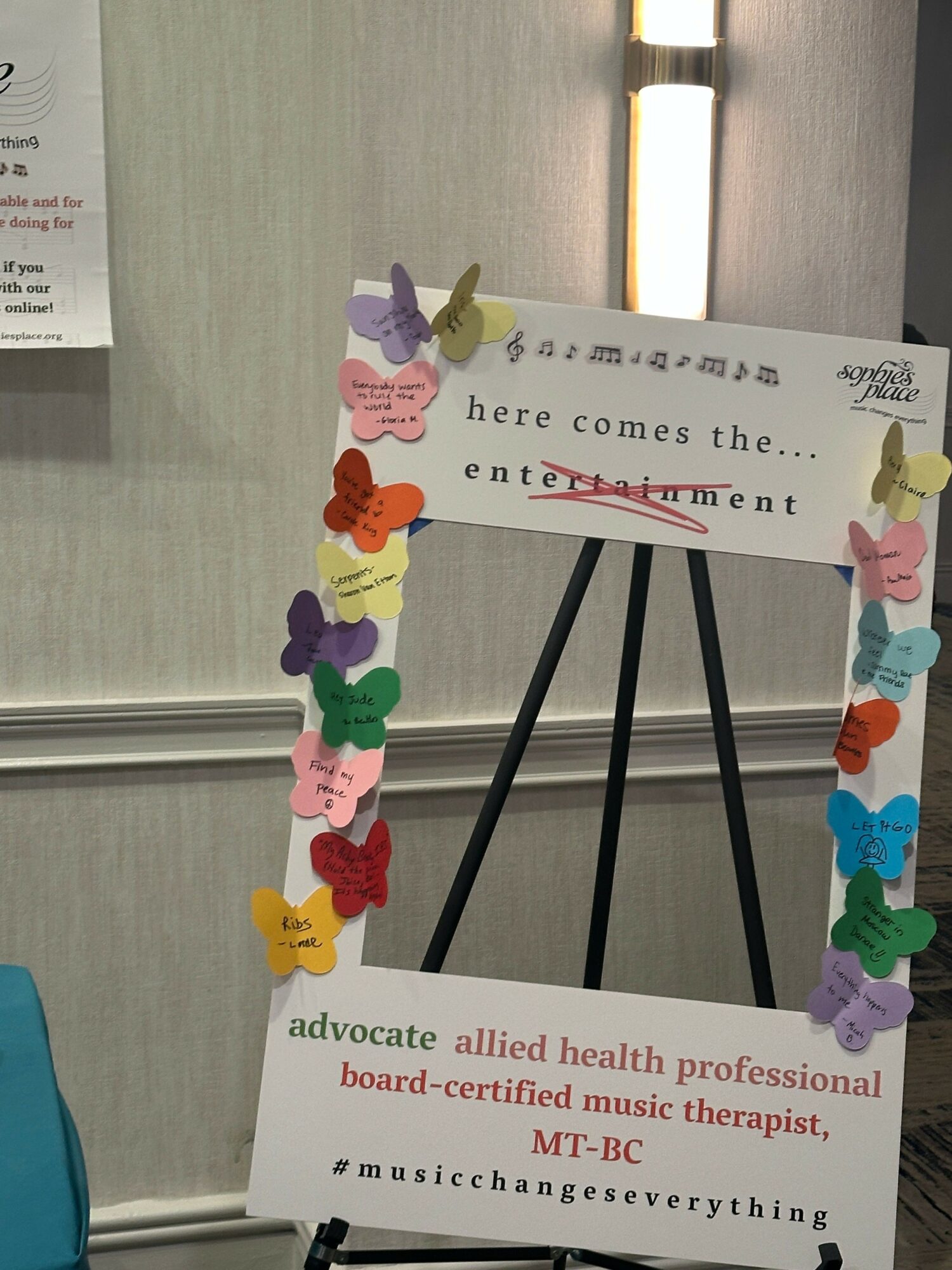 Signboard with colorful paper clips and a message about advocacy and professional board certification.