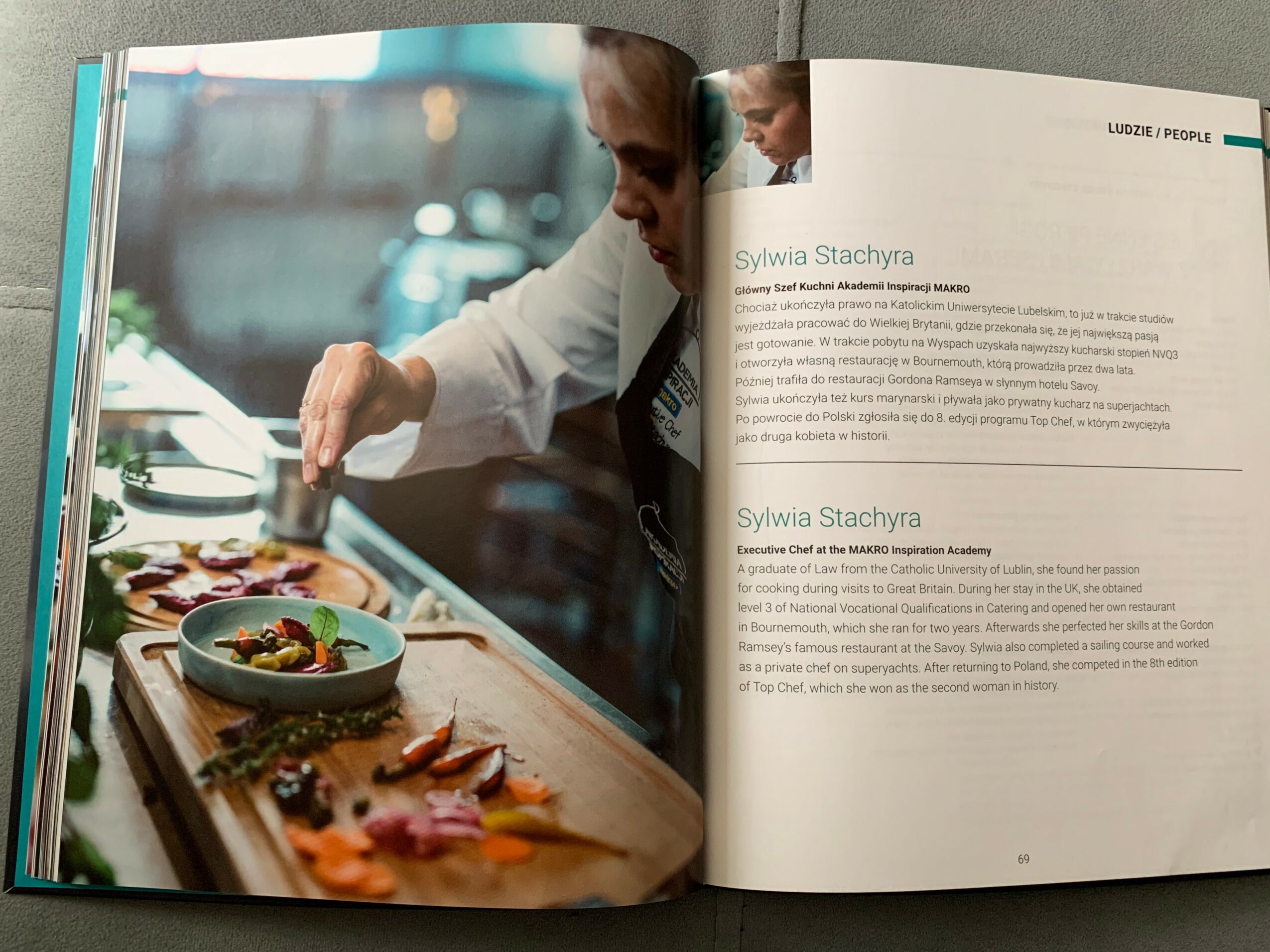 Person preparing food in a kitchen, with various ingredients on a wooden board, and a bowl of salad nearby.