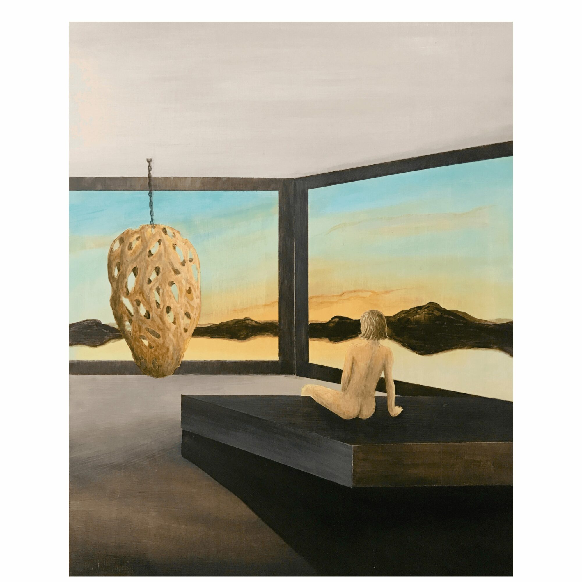 Person sitting on a platform looking out a large window at a landscape with mountains and sky, with a hanging sculpture nearby.