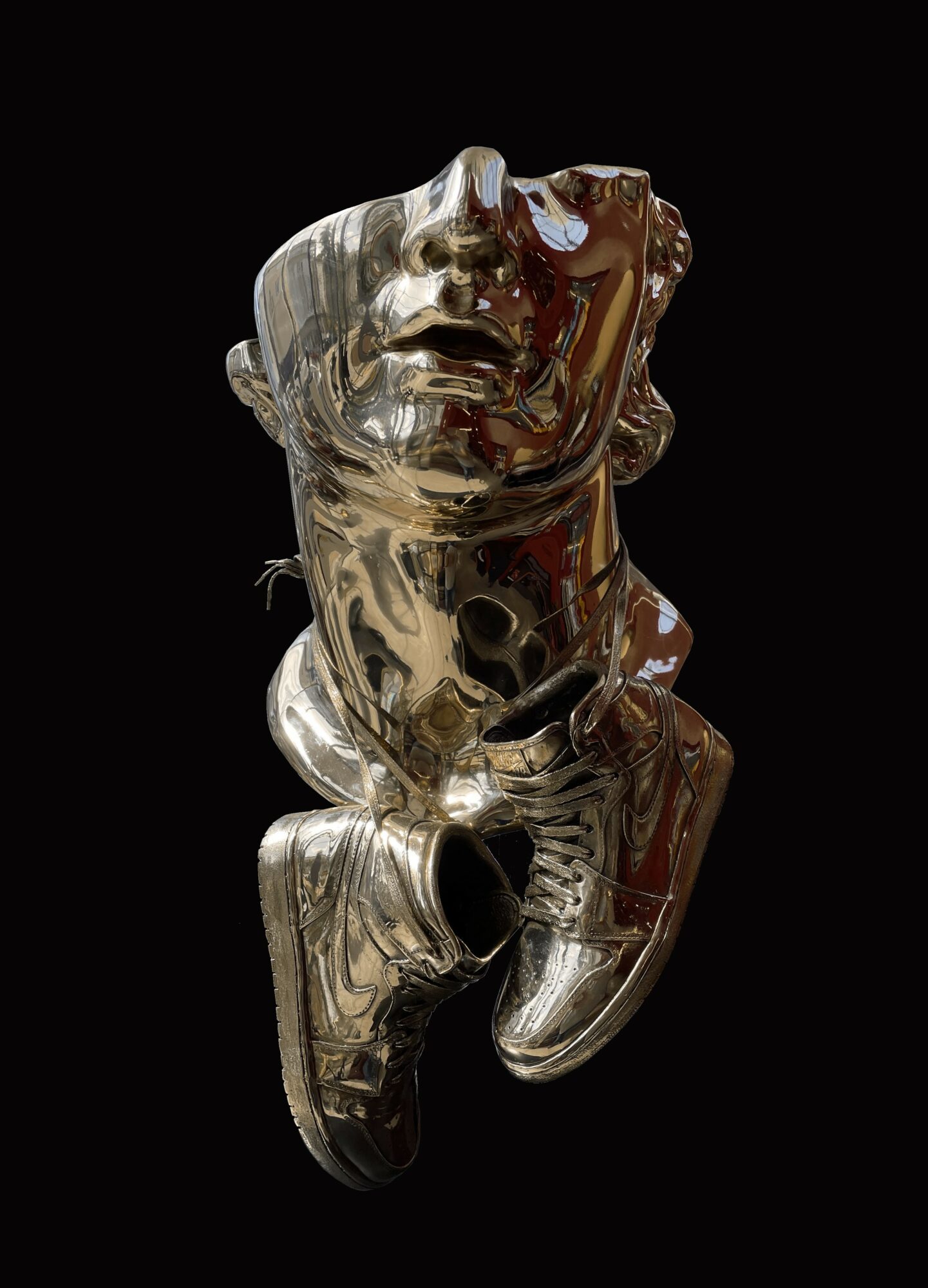 A shiny metallic sculpture of a person with an expressive face, head tilted back, against a black background.