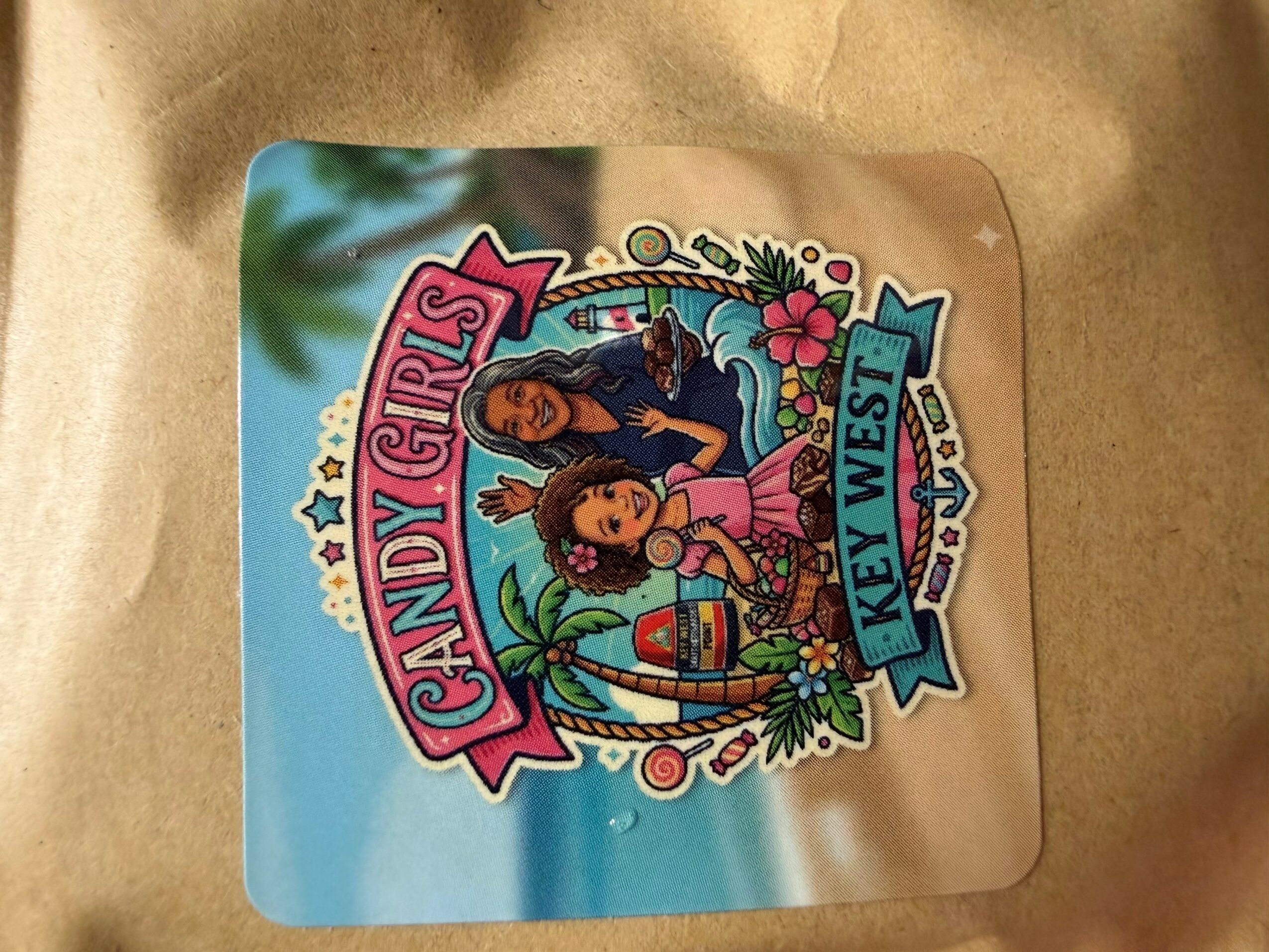 Colorful logo for Candy Girls Key West with tropical background and animated characters.