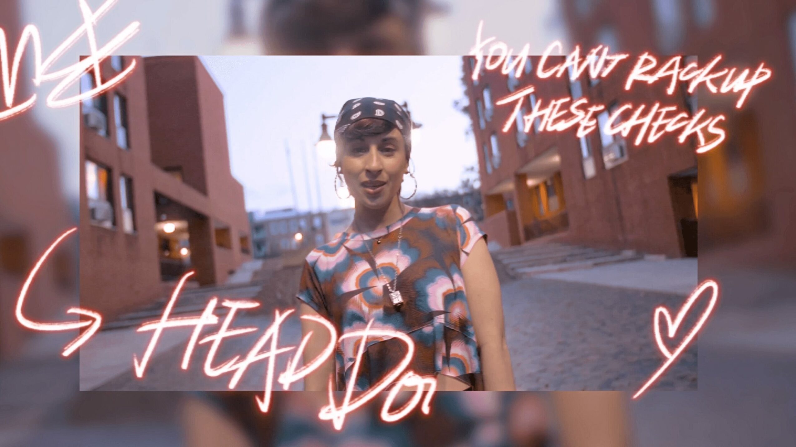 Young person standing outdoors in an urban setting, wearing a patterned shirt and headband, with handwritten-style text overlay.