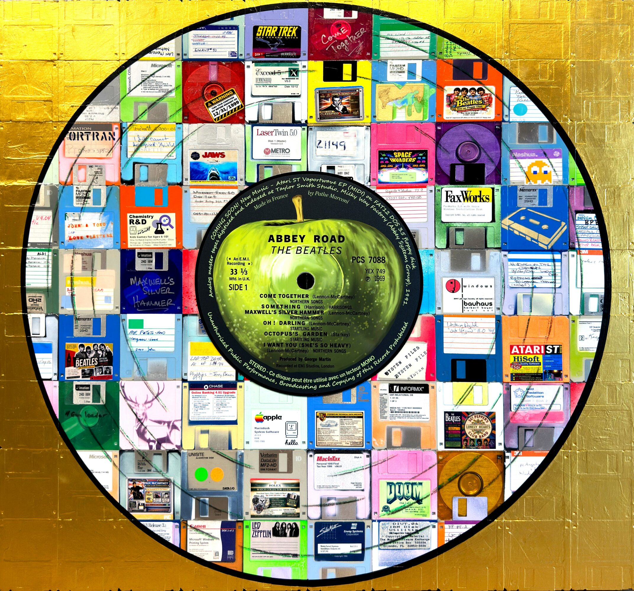 A vinyl record with a collage of colorful computer software boxes around the label, on a gold background.