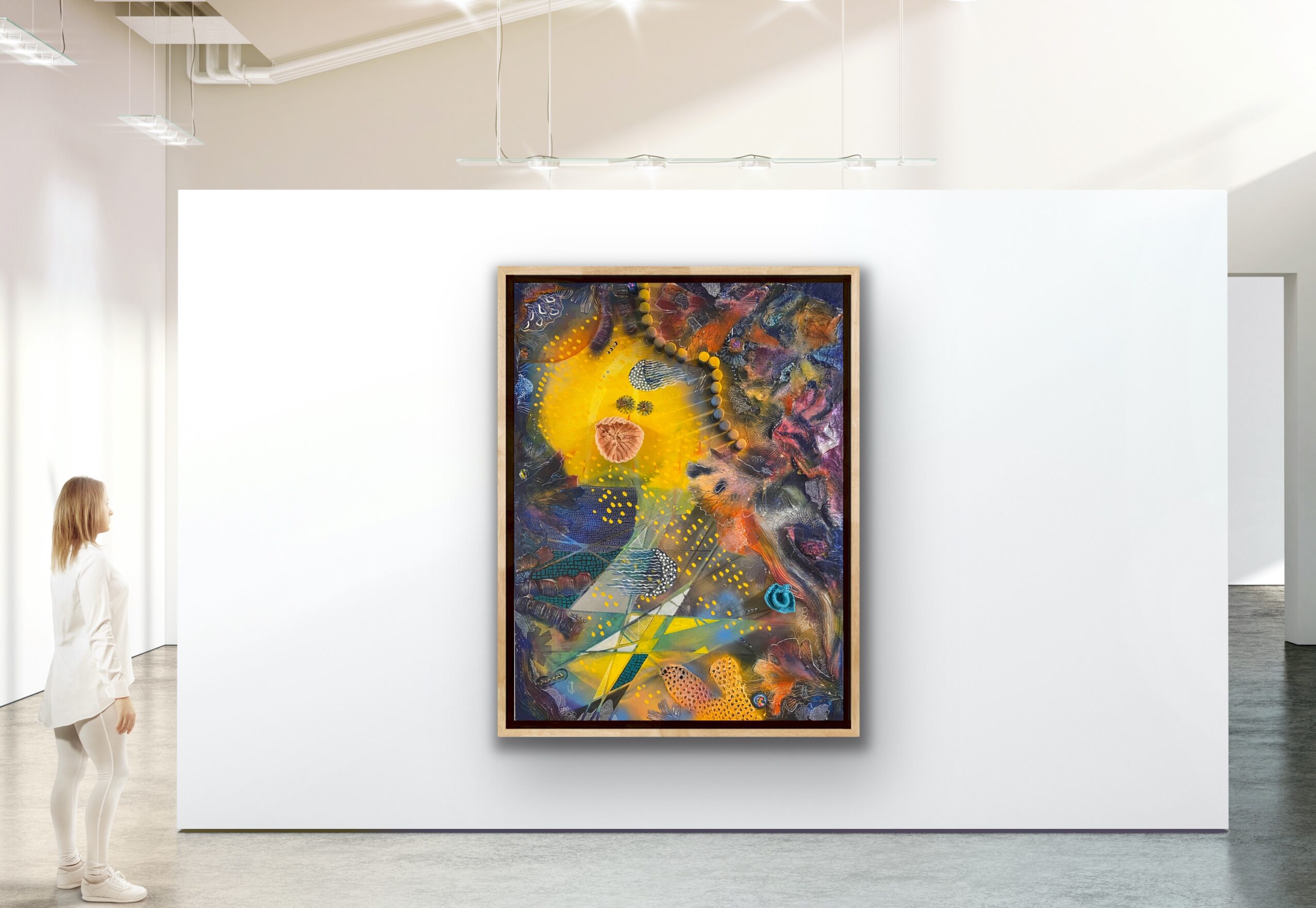 Colorful abstract painting on a white wall, with a person observing from the left side.