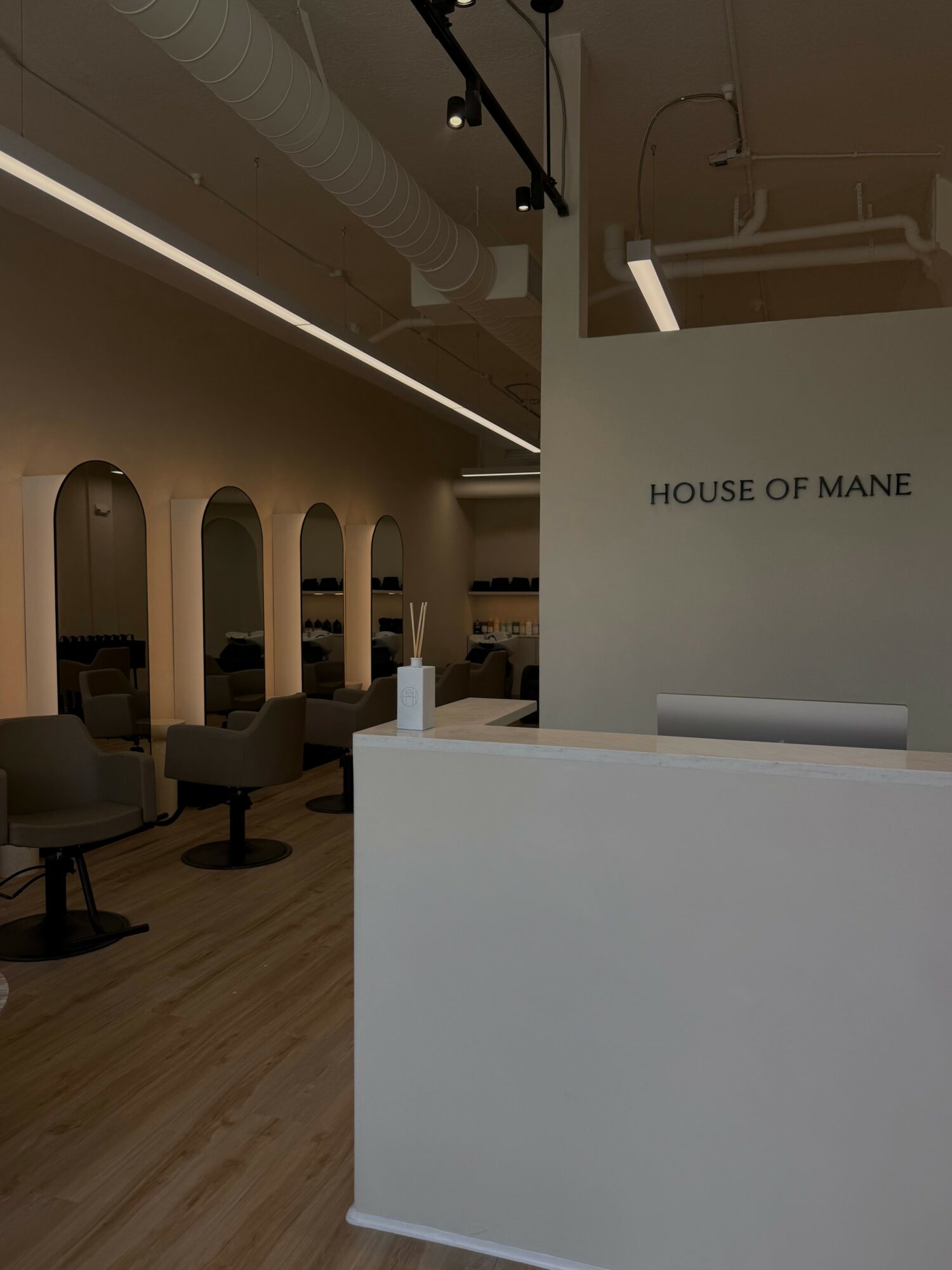 Reception area with white desk, wall with