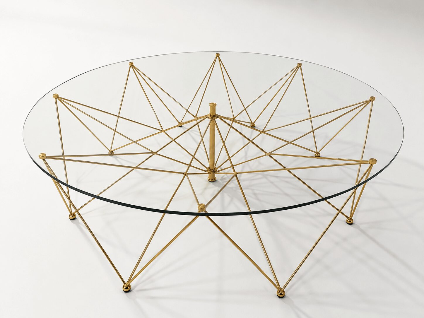 A geometric structure with interconnected gold rods and a transparent circular base, resembling a star or web pattern.