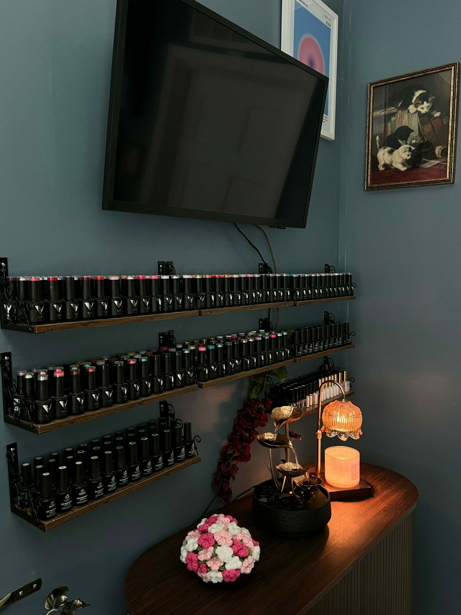 Medical vials and equipment on a table with a framed picture on the wall.