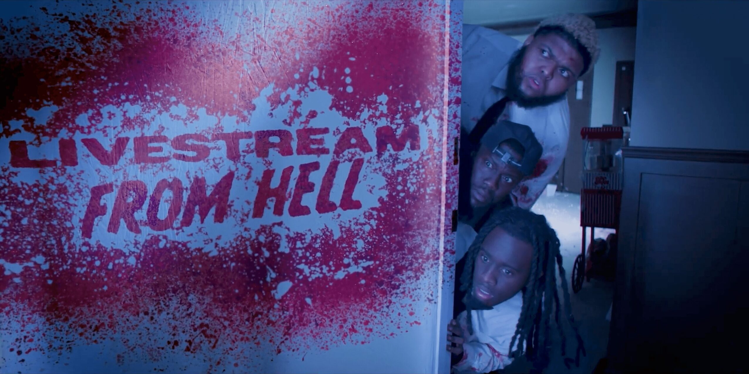 Three people peeking from behind a wall with a sign that reads 'LIVESTREAM FROM HELL' in red and pink spray paint.