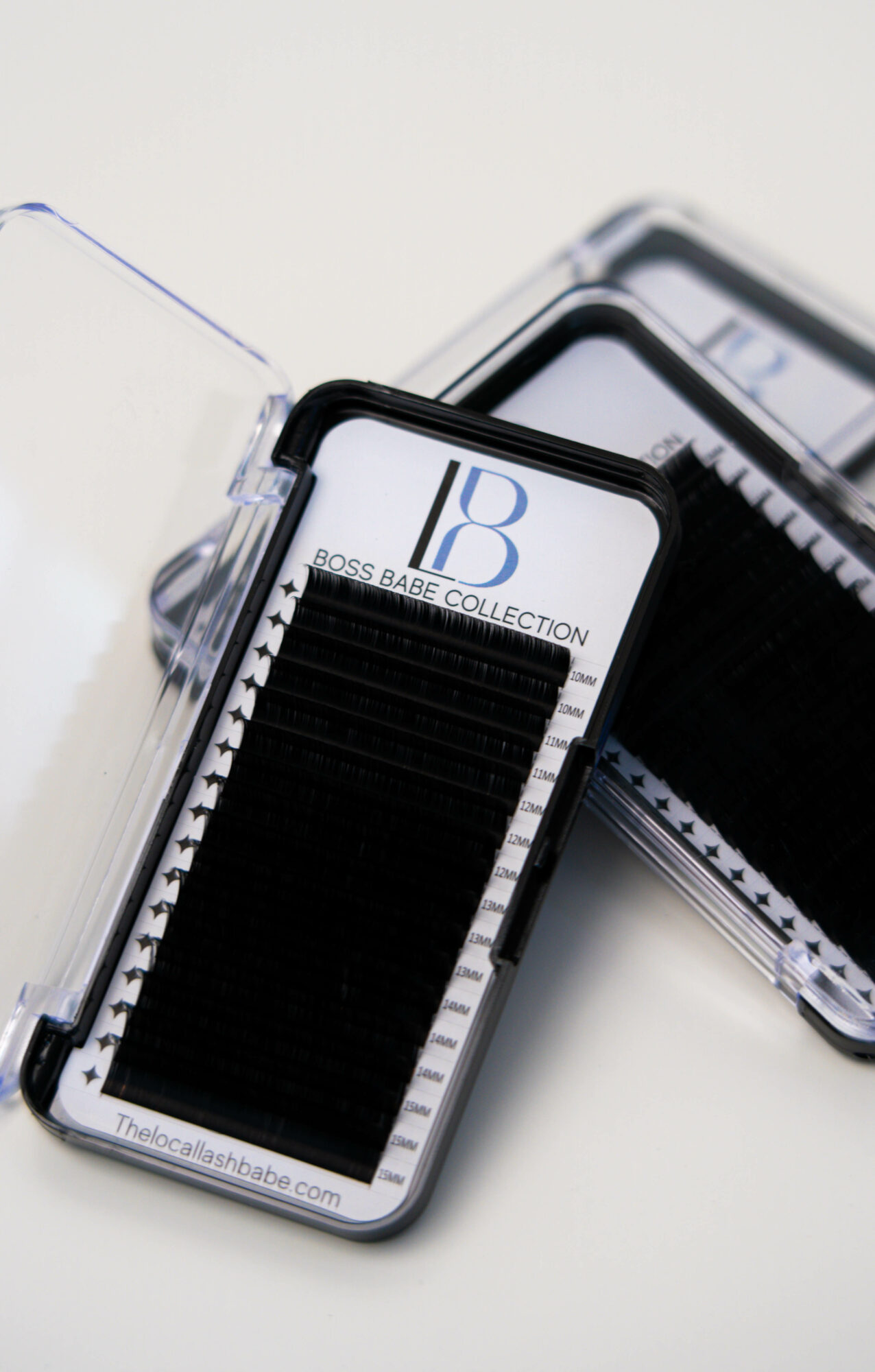 Two transparent plastic cases with black and white design, one with a logo and text, placed on a white surface.