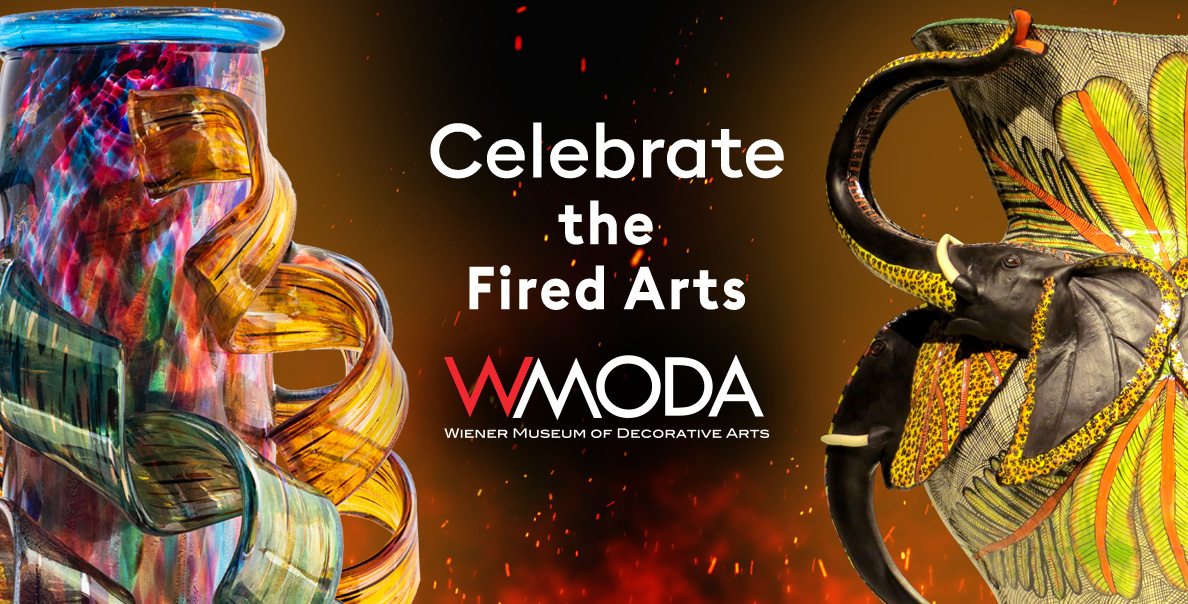 Colorful glass sculpture and decorated fire art piece with text promoting WMODA celebration.