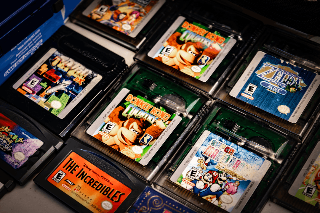Multiple Nintendo Switch game cases, including titles like Dragon Ball, The Incredibles, and others, arranged in a display.