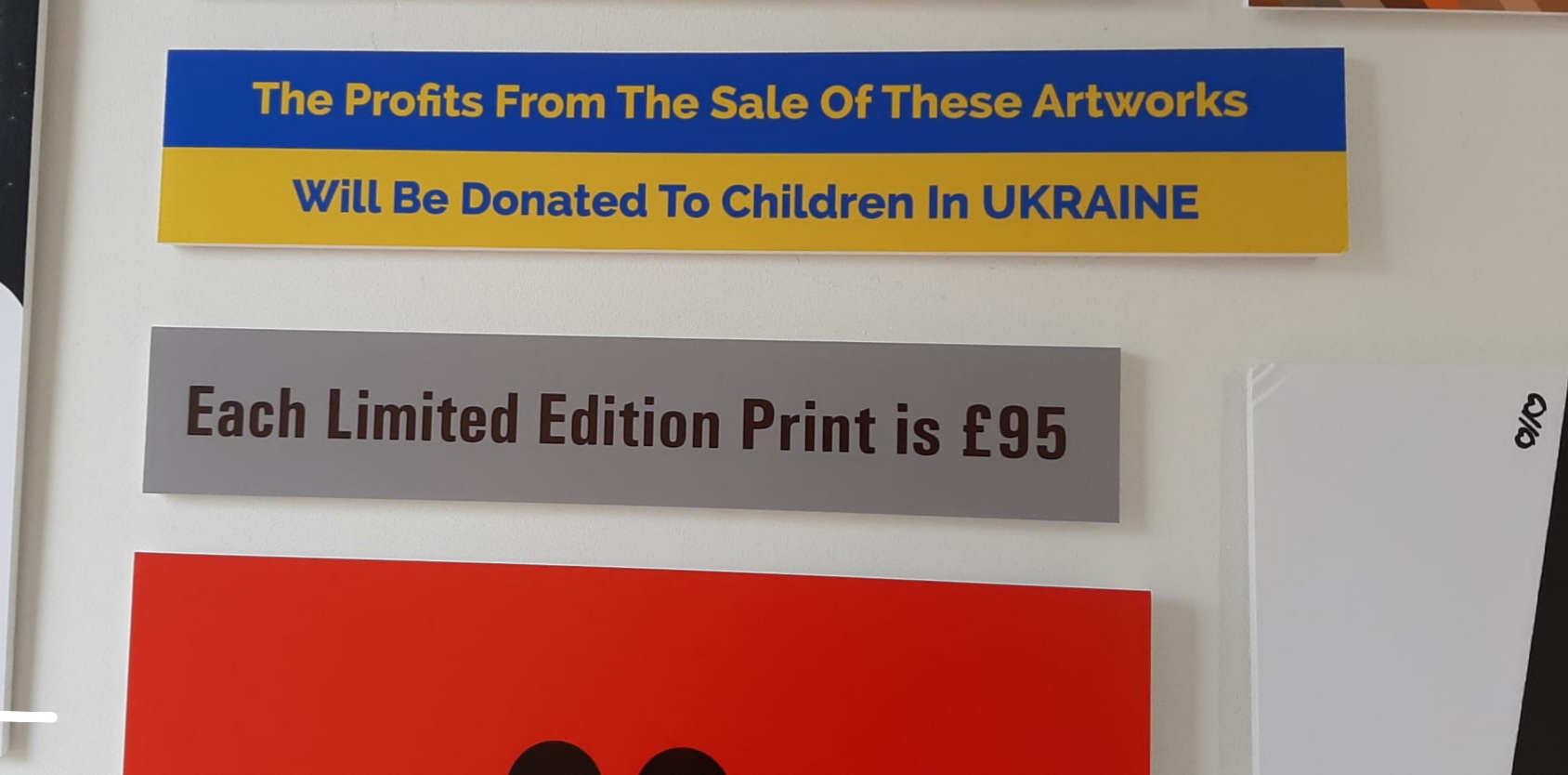 Sign with blue and yellow background, text about profits and donations to Ukraine, and a gray section about limited edition print price.