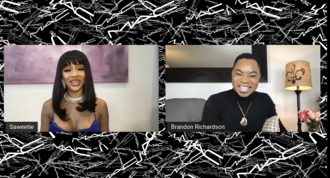 Two people smiling in a video call, one woman with dark hair and a necklace, one man with short hair and a black shirt.